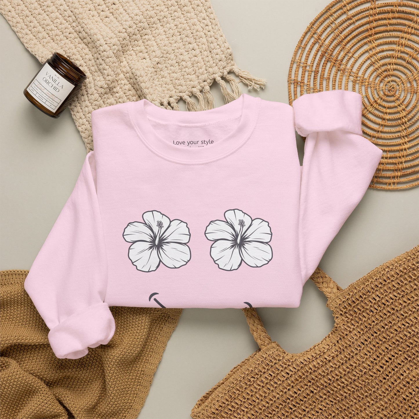 Pink folded Happy Hibiscus Sweatshirt featuring a cheerful hibiscus flower smile design inspired by island life and aloha style.