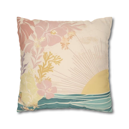 A square decorative throw pillow featuring a tropical beach scene print with pink hibiscus flowers, a yellow sun, teal ocean waves, and a cream background.