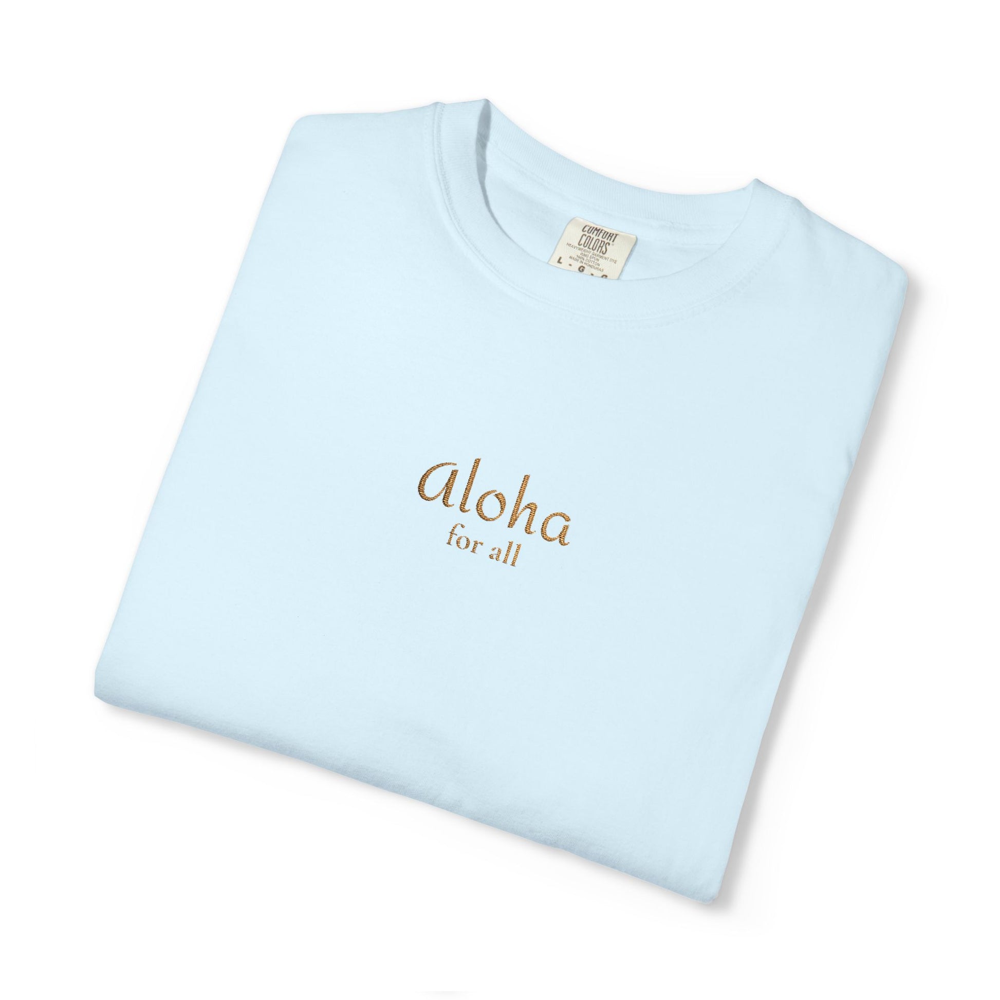 A folded light blue crewneck t-shirt with 'Aloha for all' printed in gold on the chest, displayed on a clean white background.