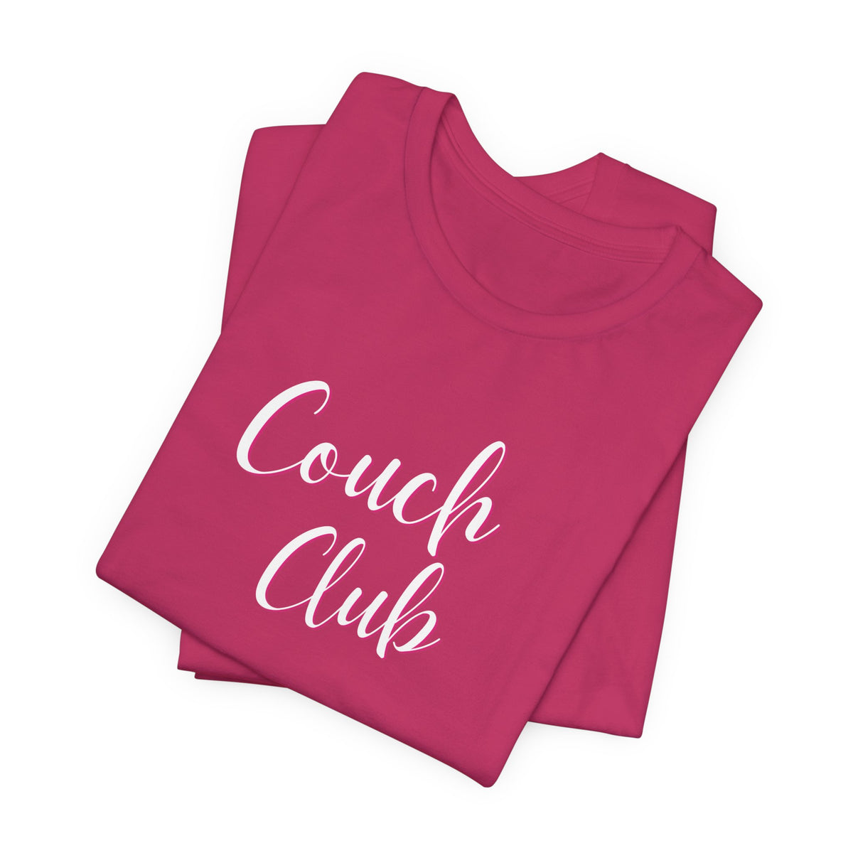 A folded magenta pink t-shirt with 'Couch Club' printed in white script across the front, displayed on a clean white background.