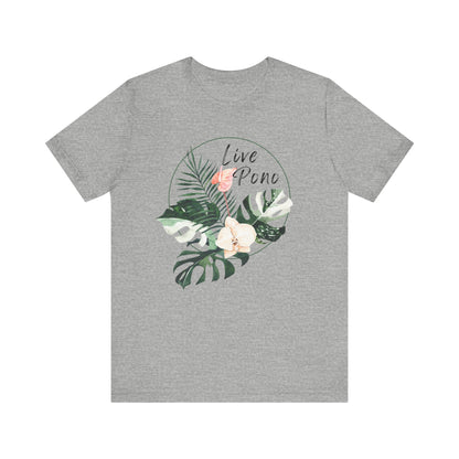 A heather gray short-sleeve crewneck t-shirt featuring a circular tropical graphic on the chest with green leaves, a pink flower, and a white orchid, with the words 'Live Pono' written in black script.