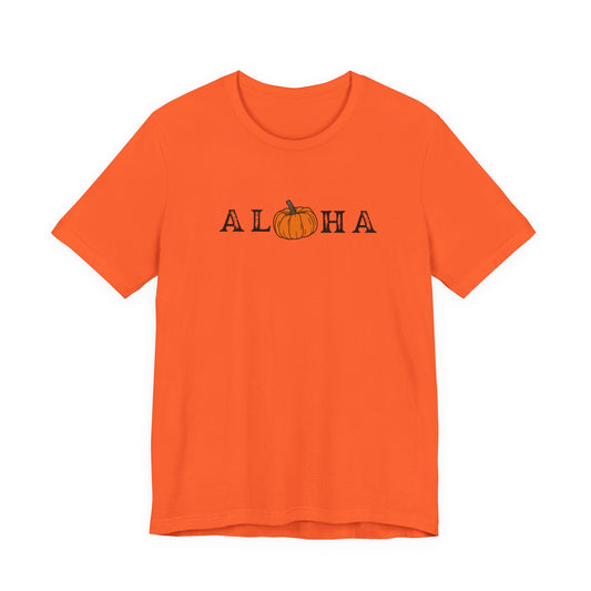An orange short-sleeve crewneck t-shirt featuring the word 'ALOHA' printed across the chest in black letters, with the 'O' replaced by a small orange pumpkin graphic.