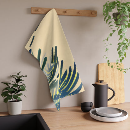 A kitchen towel with a blue and green palm leaf pattern hanging from a wooden peg on a beige wall above a kitchen counter with a coffee pot, plates, and plants.