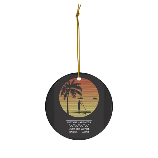 Black ceramic ornament with sunset stand-up paddler scene, palm tree, Mokulua islands and Instant Happiness Just Add Water Kailua Hawaiʻi design.
