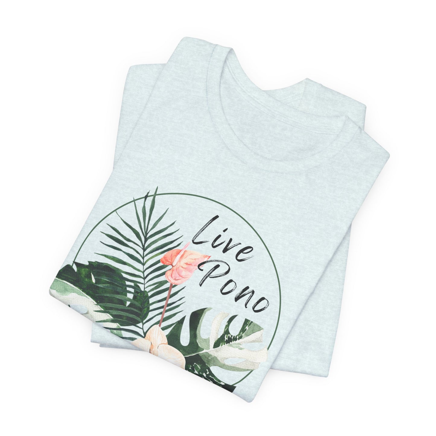 A folded light heather blue t-shirt with a tropical graphic print featuring palm leaves, a pink flower, and the text 'Live Pono' inside a circular design, set against a plain white background.