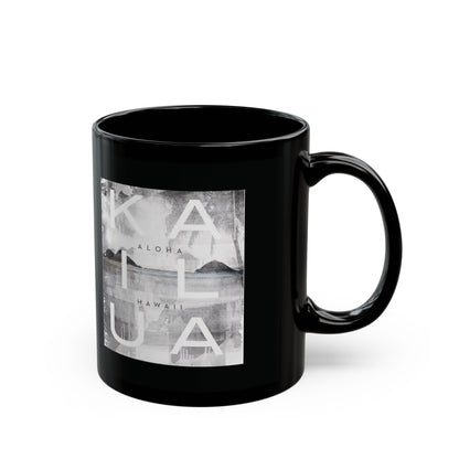 A glossy black ceramic mug featuring a square grayscale graphic print on the front with the words 'KAILUA', 'ALOHA', and 'HAWAII' over a landscape image, shown on a white background.