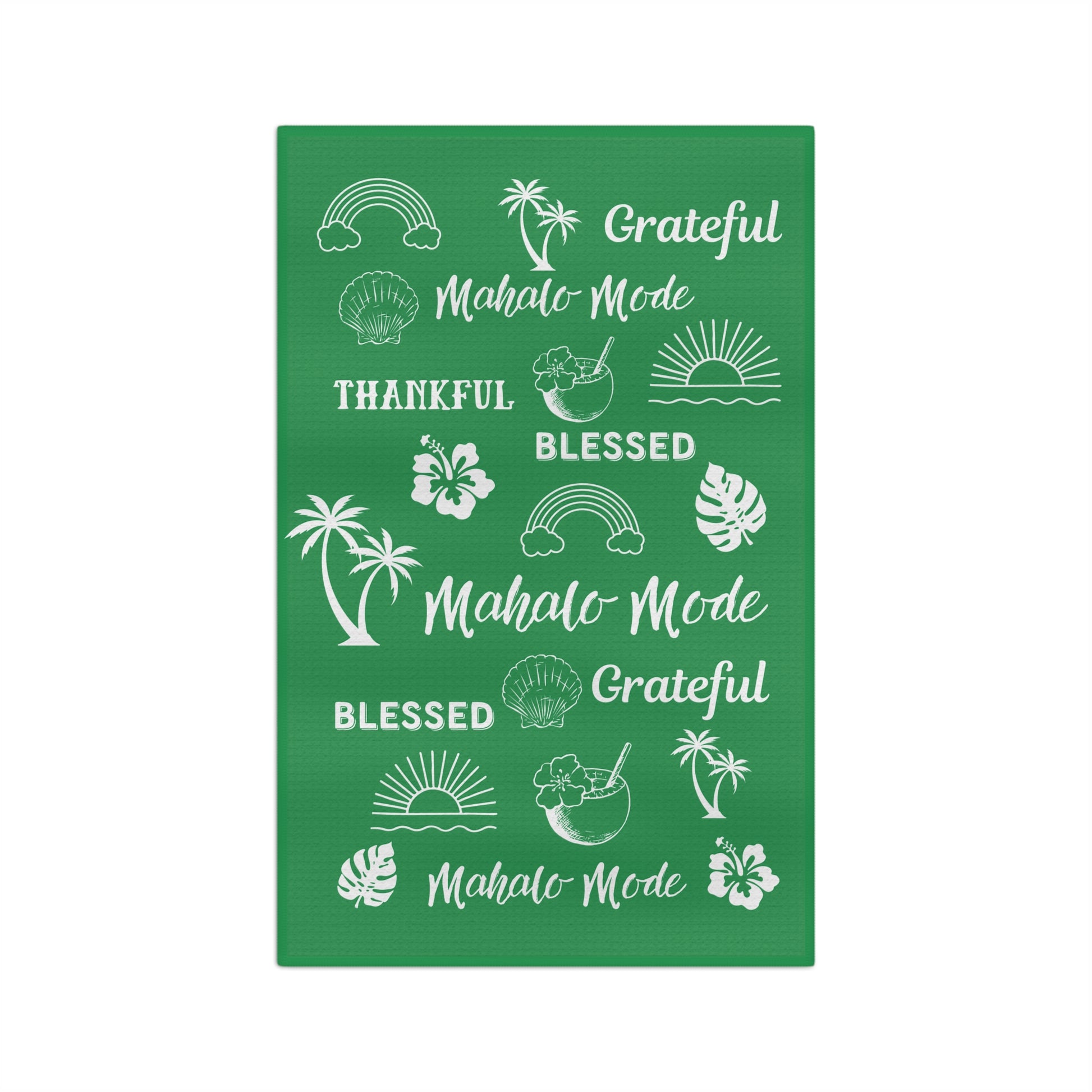 A green kitchen towel with white tropical-themed illustrations and phrases including 'Grateful Mahalo Mode,' 'THANKFUL,' 'BLESSED,' and 'Mahalo Mode,' shown on a plain white background.