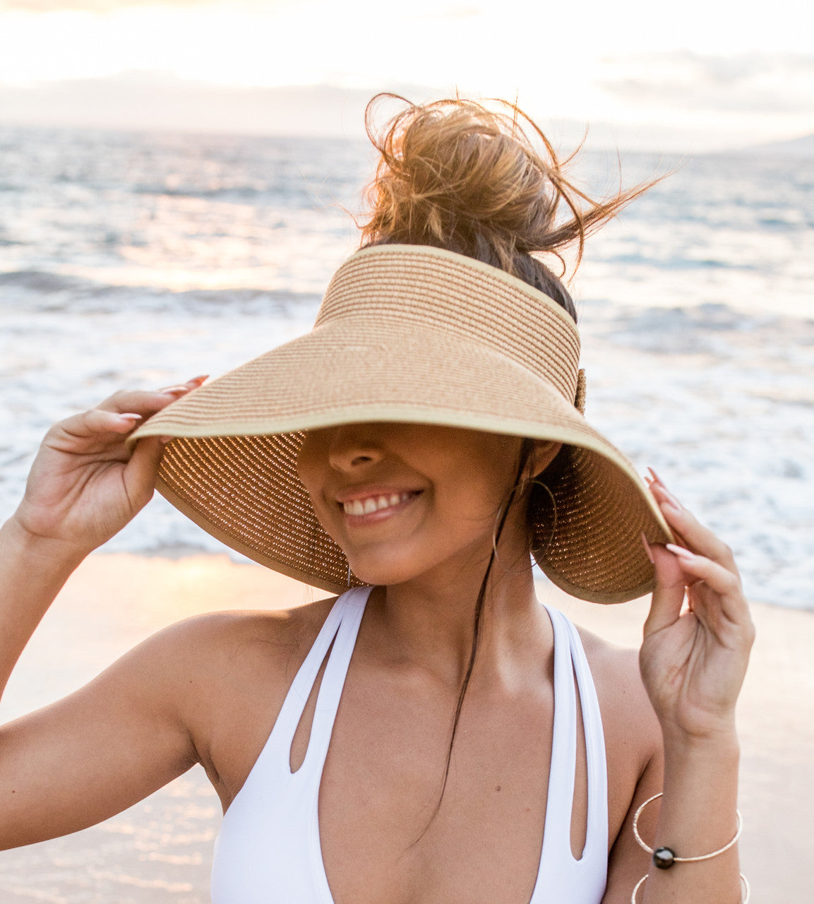 Woman wearing a wide-brimmed hat on a beach