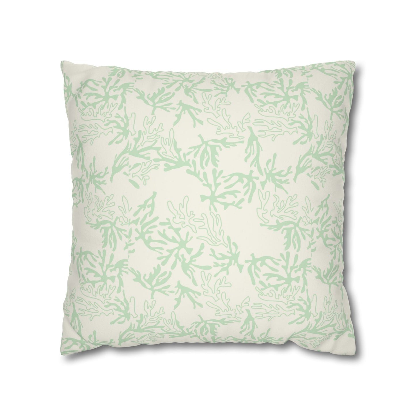A square throw pillow featuring a light sage green coral pattern on an off-white background, shown against a plain white studio backdrop.