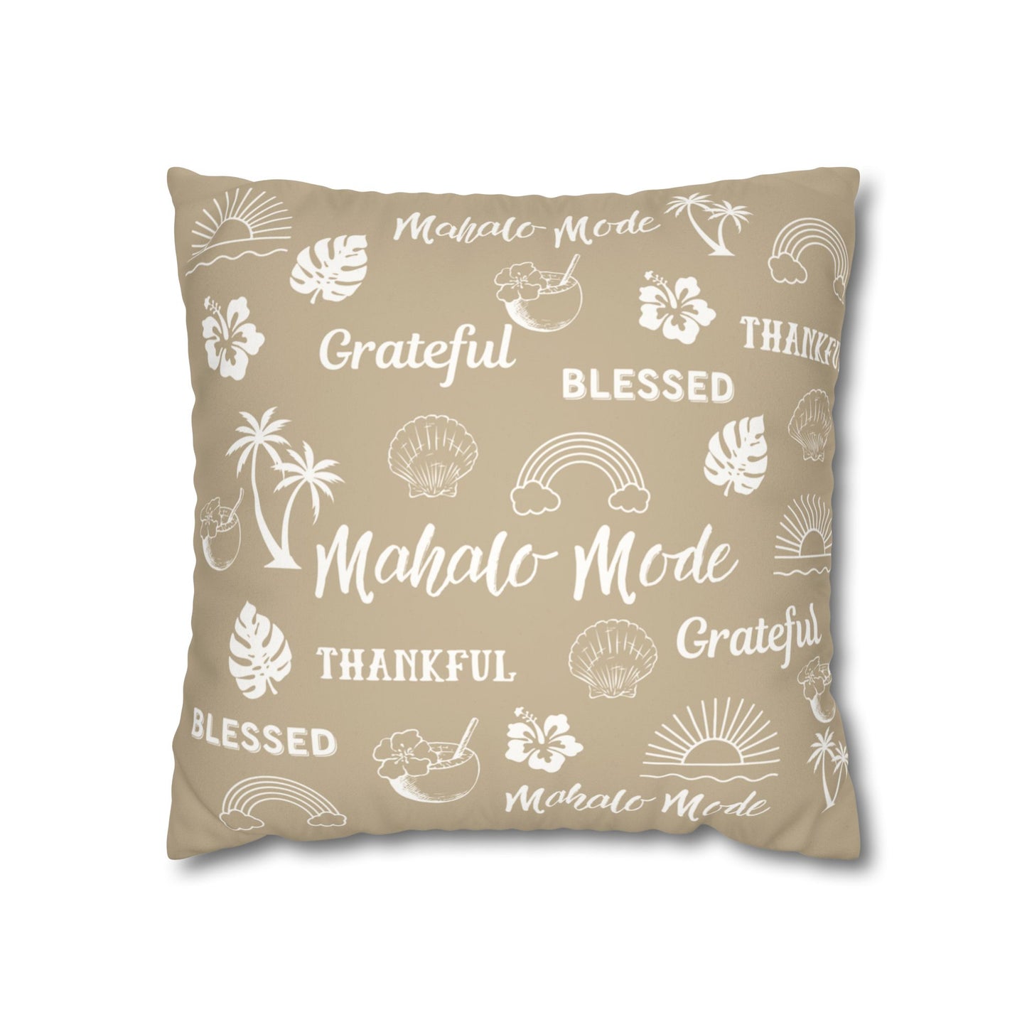 A square throw pillow in a warm beige color, printed with white tropical-themed illustrations and words including 'Mahalo Mode', 'Grateful', and 'Blessed'.