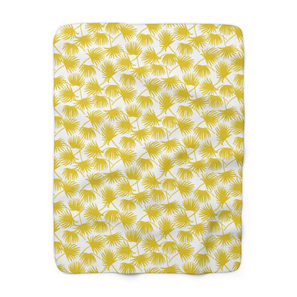 A rectangular throw blanket with a yellow palm frond pattern on a white background, shown flat against a white backdrop.