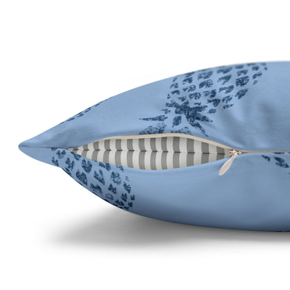 A light blue throw pillow with a dark blue floral pattern, shown open to reveal a striped cushion insert, on a white background.