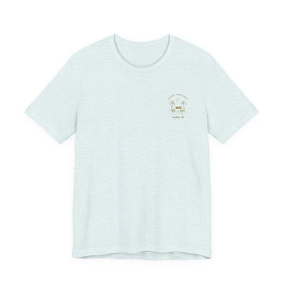 A light blue short-sleeve t-shirt shown from the front, featuring a gold-colored retro graphic of a classic car between two palm trees with the text 'ALOHA DREAMIN'' and 'Kailua, HI' on the left chest.