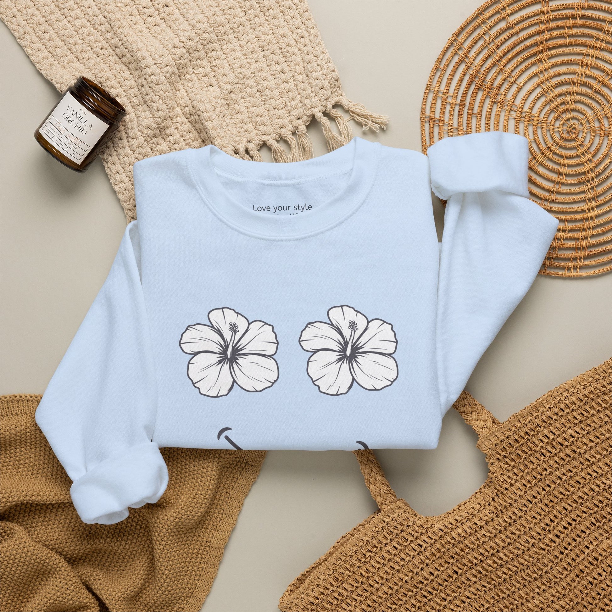 Lt. Blue folded Happy Hibiscus Sweatshirt featuring a cheerful hibiscus flower smile design inspired by island life and aloha style.