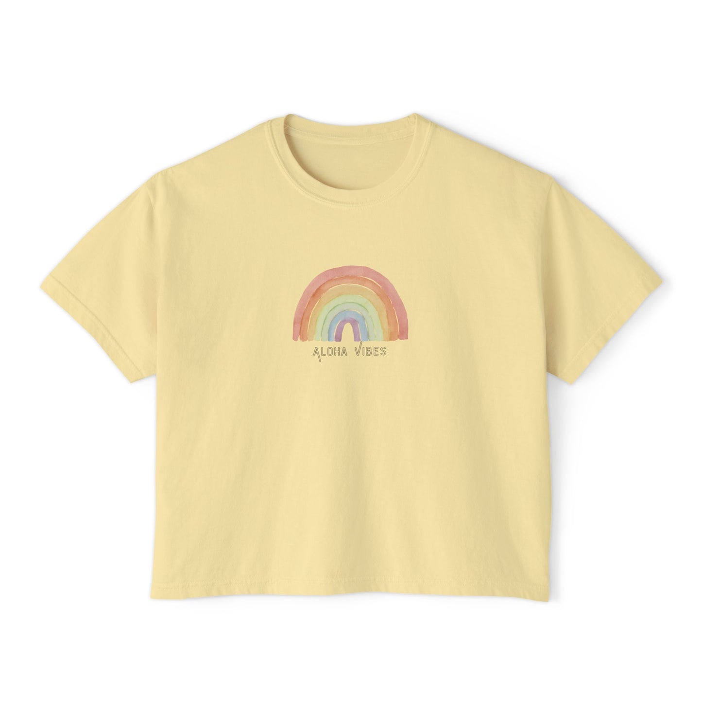 A pale yellow short-sleeve crop top t-shirt featuring a pastel rainbow graphic and the text 'ALOHA VIBES' printed on the chest, displayed against a solid white background.