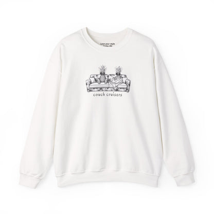 An white crewneck sweatshirt featuring a black line art graphic of a couch with two pineapples and the text 'couch cruisers' printed on the chest.