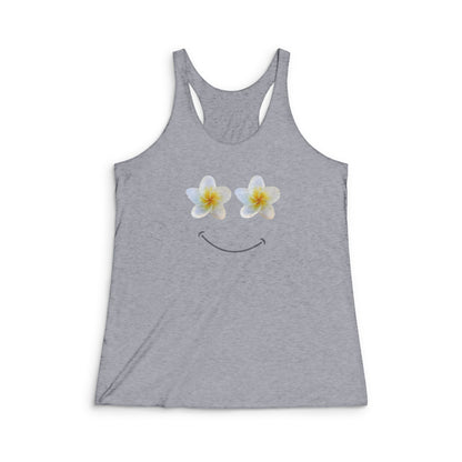 A heather gray racerback tank top featuring a smiley face graphic where the eyes are made of two white plumeria flowers with yellow centers, shown on a plain white background.