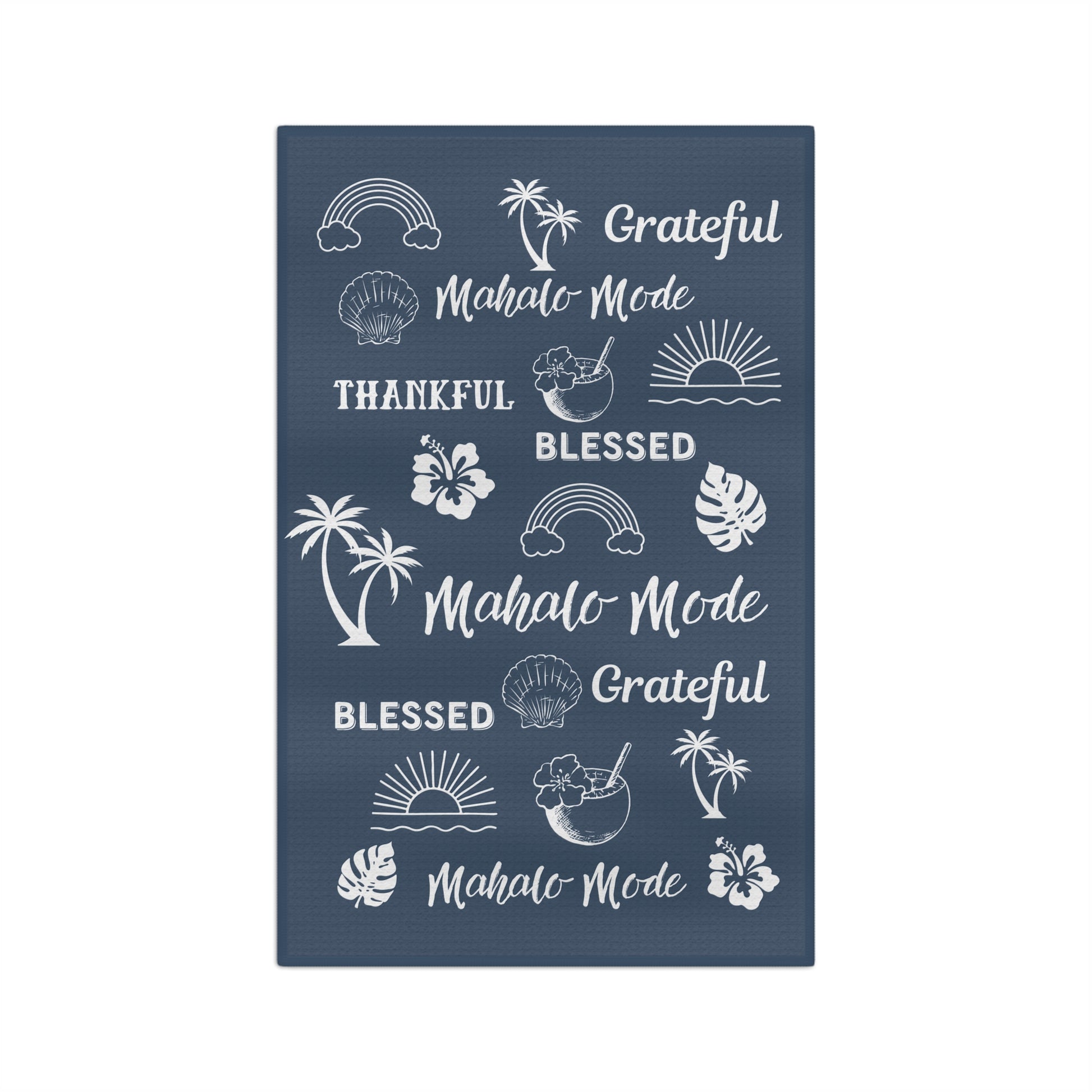 A denim blue kitchen towel with white tropical-themed illustrations and phrases including 'Grateful Mahalo Mode,' 'THANKFUL,' 'BLESSED,' and repeated 'Mahalo Mode' text, shown on a plain white background.