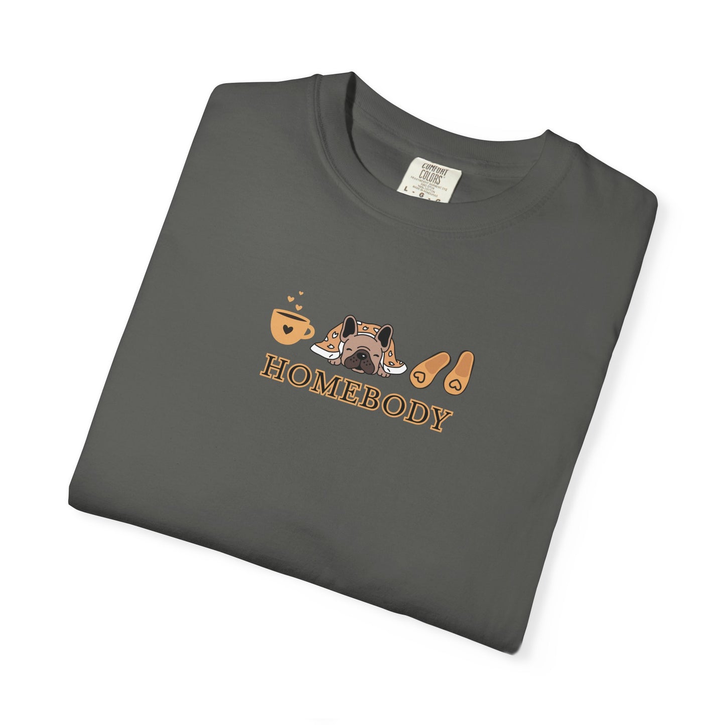 A folded dark gray short-sleeve crewneck t-shirt with a graphic on the chest depicting a dog under a blanket, a coffee mug, a pair of house slippers, and the word 'HOMEBODY' in brown text.