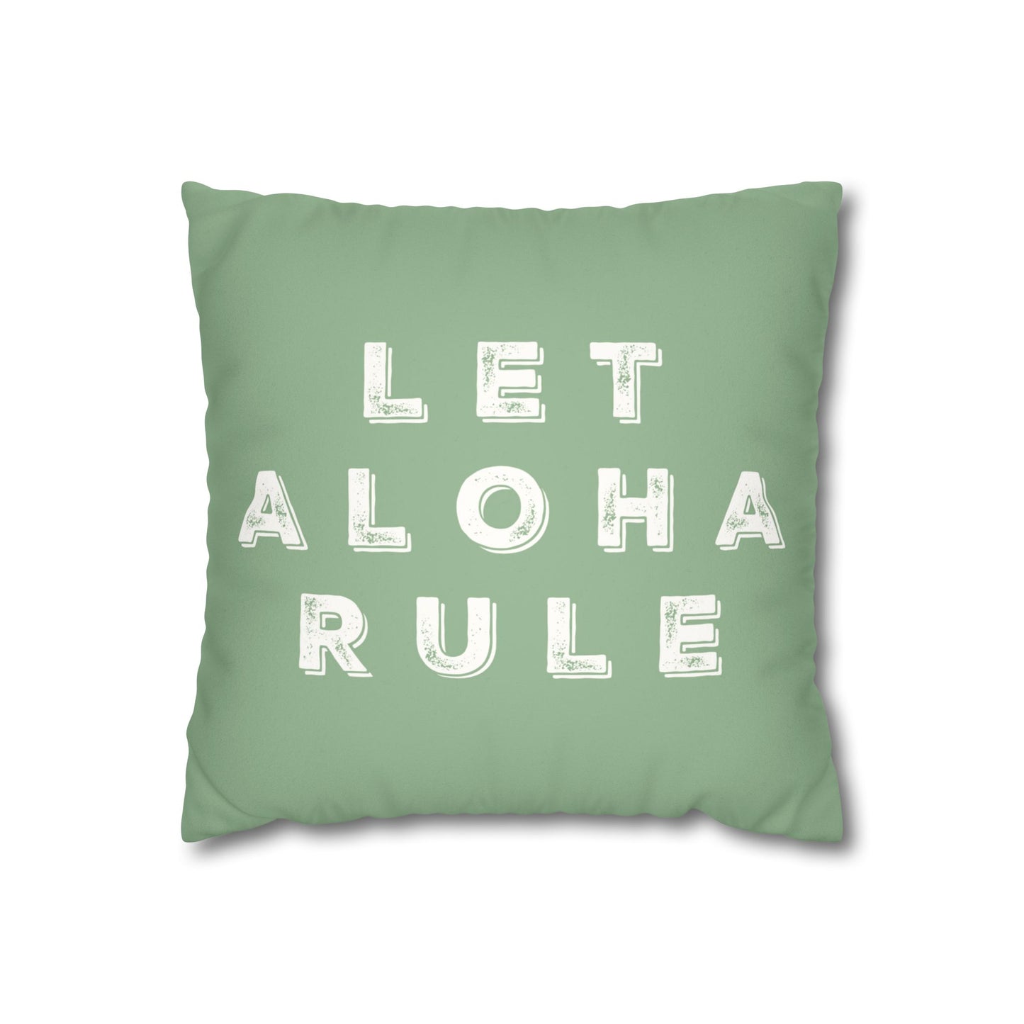 A square mint green throw pillow featuring the phrase 'LET ALOHA RULE' printed in distressed white block letters, shown against a plain white background.
