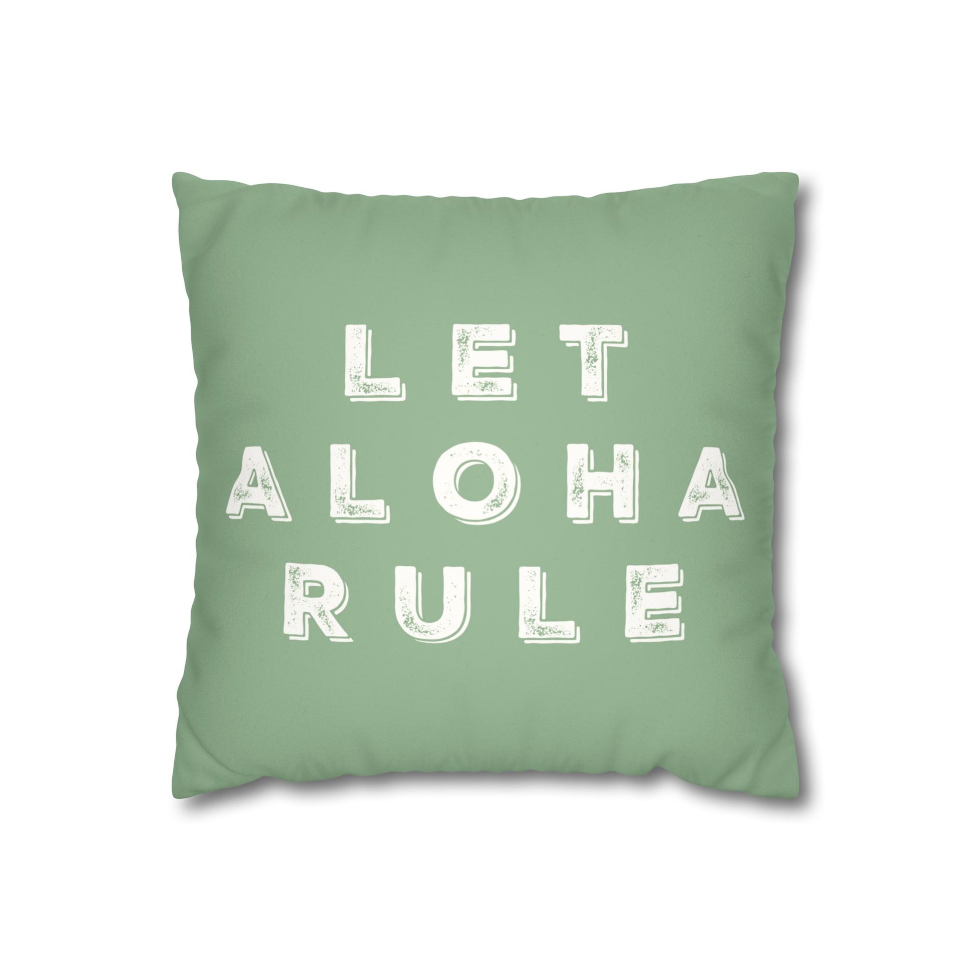 A square mint green throw pillow featuring the phrase 'LET ALOHA RULE' printed in distressed white block letters, shown against a plain white background.