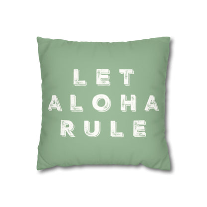A square mint green throw pillow featuring the phrase 'LET ALOHA RULE' printed in distressed white block letters, shown against a plain white background.