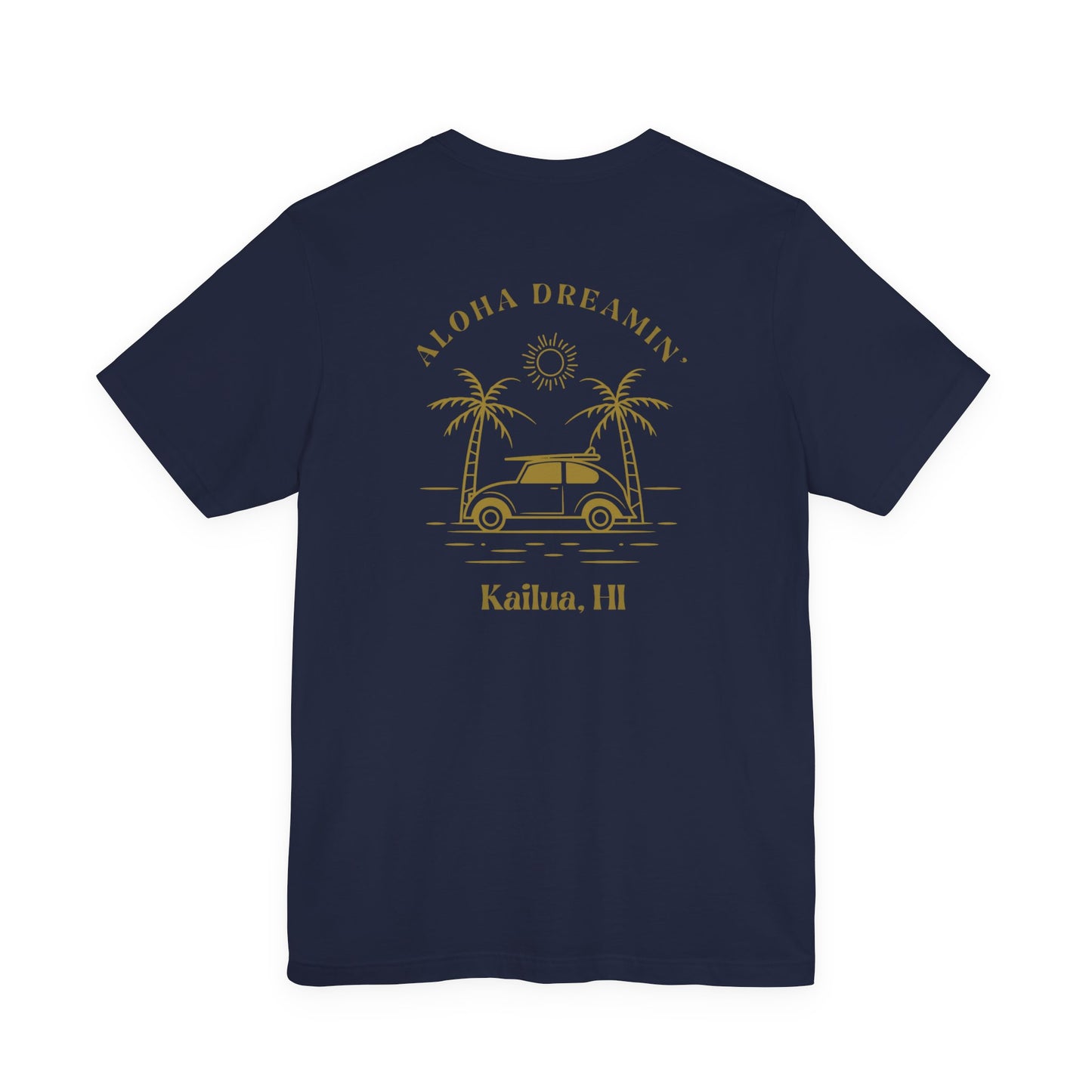 A navy short-sleeve t-shirt shown from the back, featuring a gold-colored retro graphic of a classic car between two palm trees with the text 'ALOHA DREAMIN'' and 'Kailua, HI'.