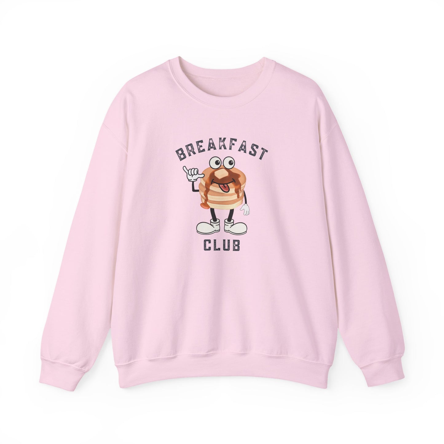 A light pink crewneck sweatshirt featuring a cartoon graphic of a breakfast stack of pancakes character with the text 'BREAKFAST CLUB' printed on the front, displayed against a clean white background.