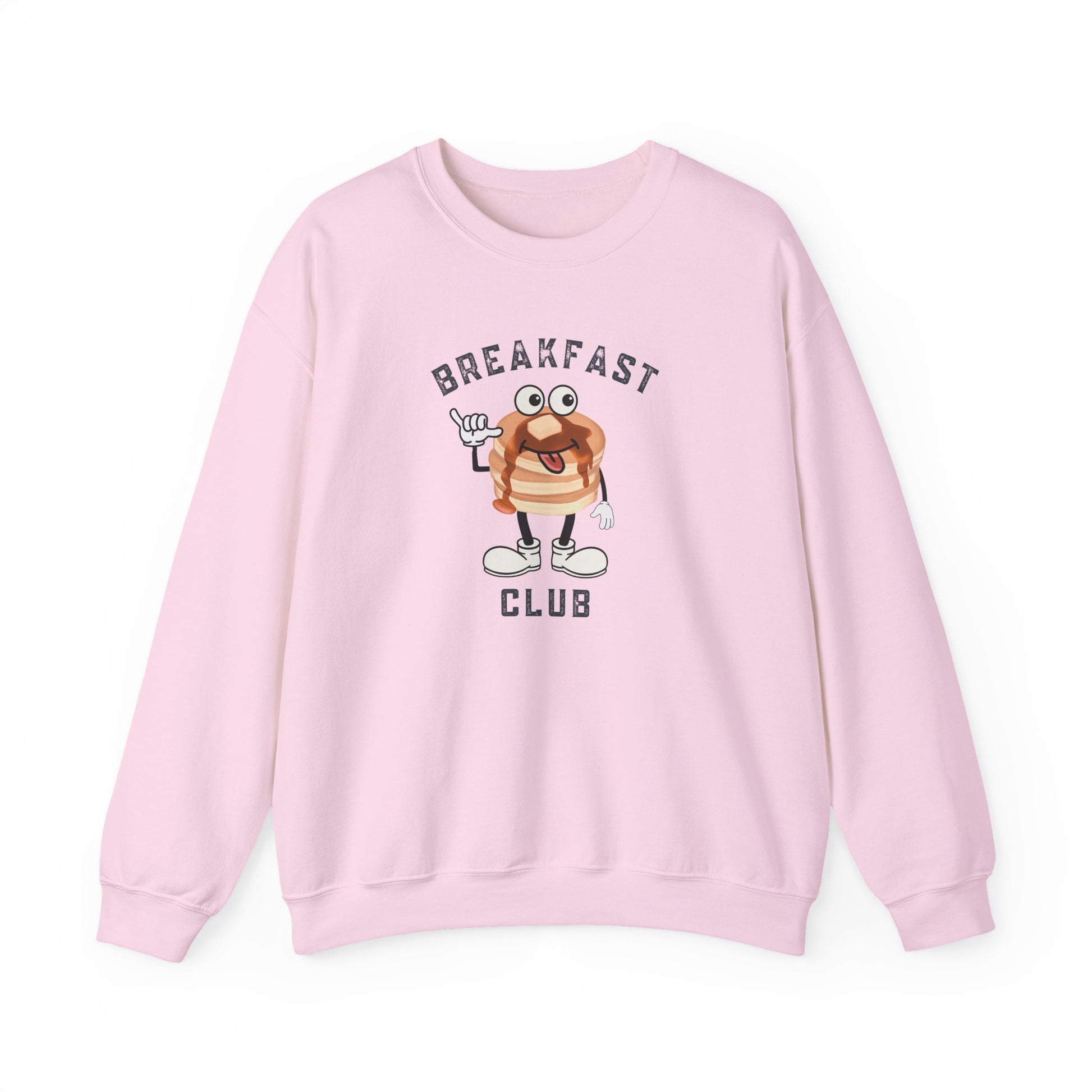 A light pink crewneck sweatshirt featuring a cartoon graphic of a breakfast stack of pancakes character with the text 'BREAKFAST CLUB' printed on the front, displayed against a clean white background.
