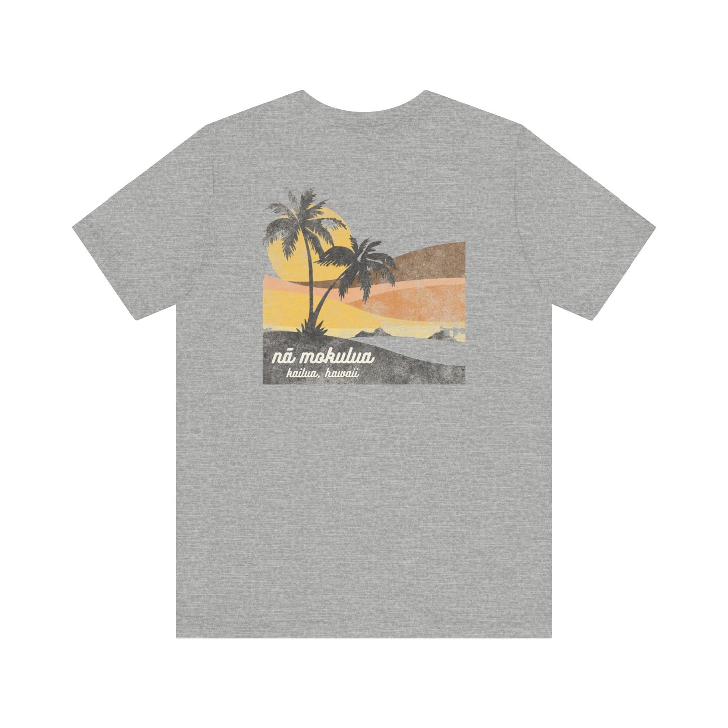 A heather gray short-sleeve t-shirt with a graphic print of a tropical sunset scene featuring palm trees, a yellow sun, and the text 'ná mokulua' and 'Kailua, Hawaii' on the back.