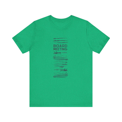 A bright green crewneck t-shirt with a dark gray graphic on the front featuring the text 'BOARD MEETING' surrounded by horizontal surfboards, displayed on a solid white background.