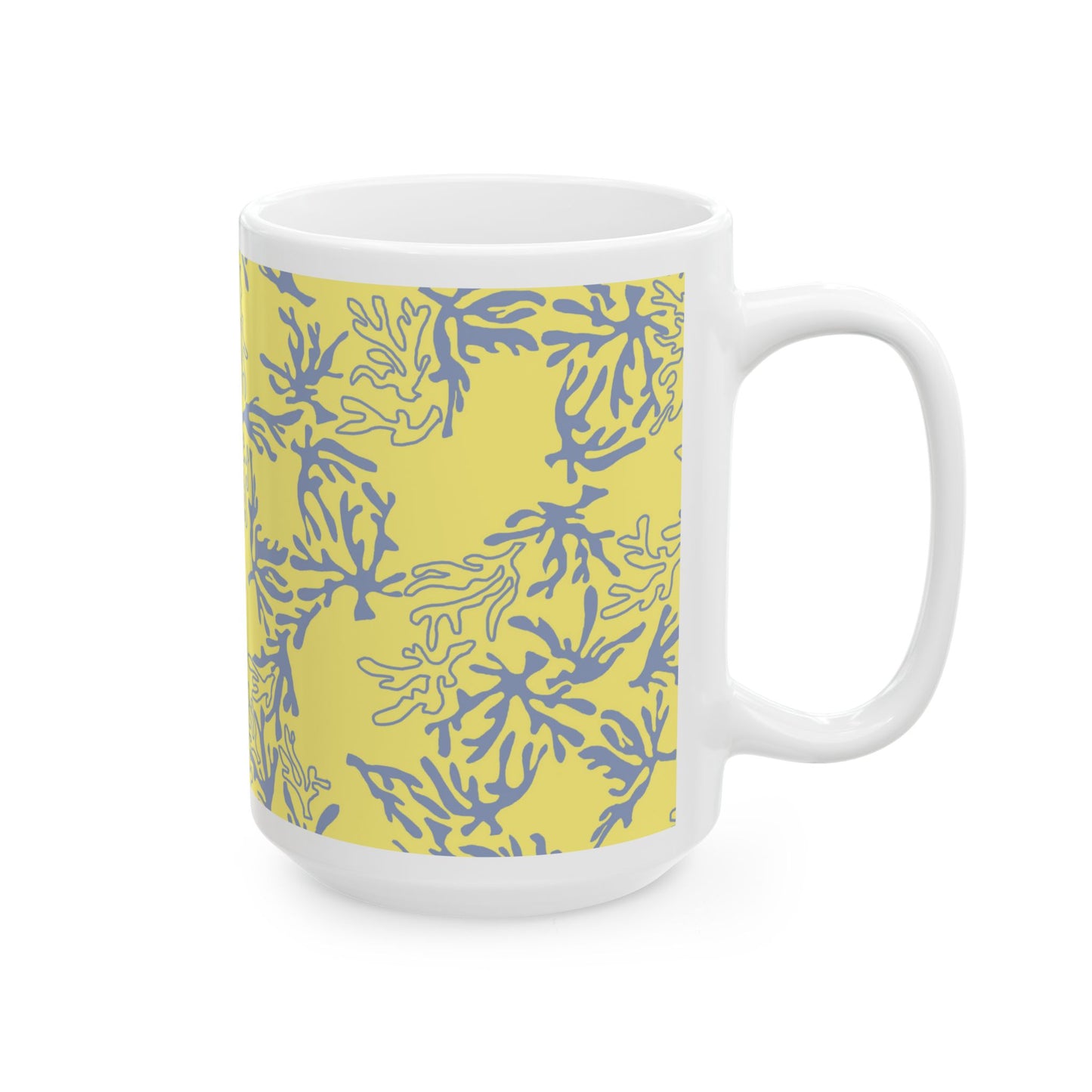 A white ceramic mug featuring a yellow wrap-around band with a blue coral pattern, set against a plain white background.
