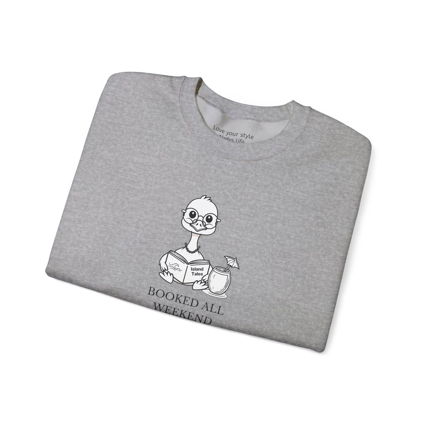 A folded heather gray crewneck t-shirt featuring a cartoon nene goose character reading a book with the text 'BOOKED ALL WEEKEND' underneath, displayed on a clean white background.