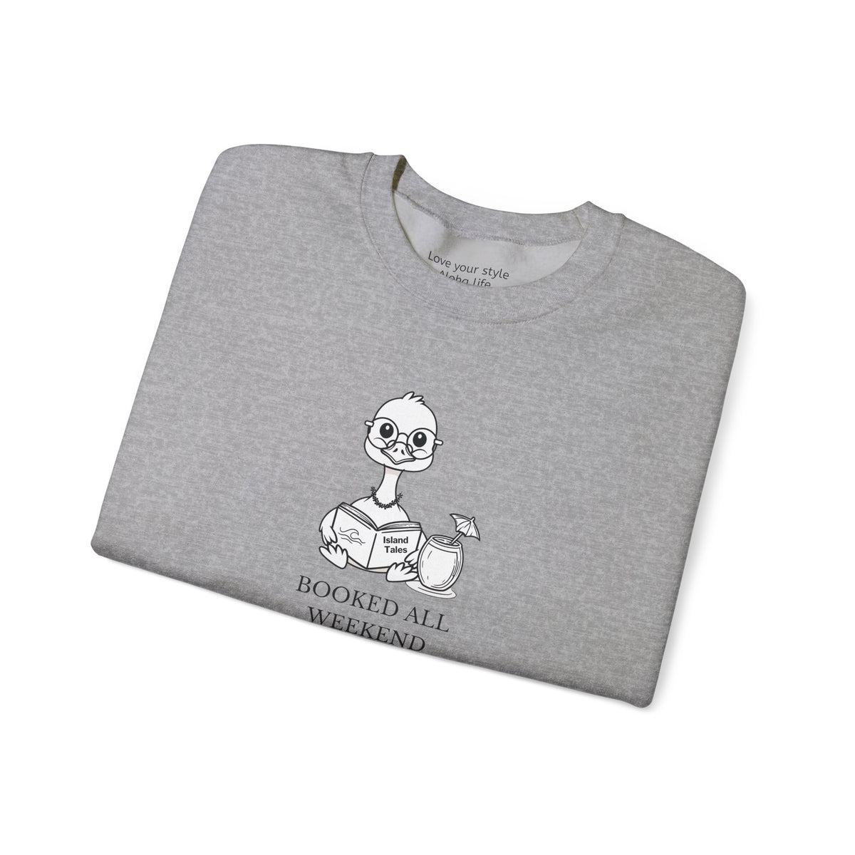 A folded heather gray crewneck t-shirt featuring a cartoon nene goose character reading a book with the text 'BOOKED ALL WEEKEND' underneath, displayed on a clean white background.