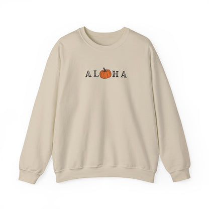 A beige crewneck sweatshirt featuring a graphic print of the word 'ALOHA' with the letter 'O' replaced by an orange pumpkin illustration, set against a plain white background.
