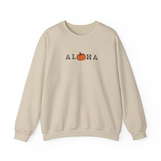 A beige crewneck sweatshirt featuring a graphic print of the word 'ALOHA' with the letter 'O' replaced by an orange pumpkin illustration, set against a plain white background.