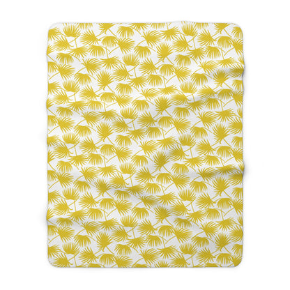 A fleece throw blanket, featuring a repeating yellow palm leaf pattern on a white background.