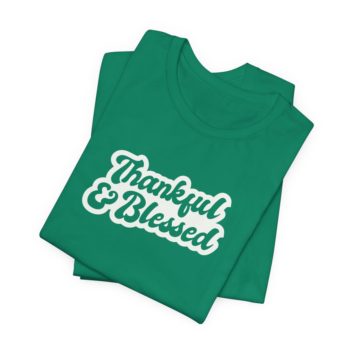 A folded green t-shirt with the words 'Thankful & Blessed' printed in white cursive text with a light blue outline, shown on a plain white background.