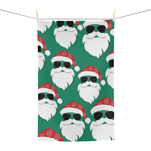 Cool Santa Aloha Kalikimaka kitchen towel with sunglasses Santa, tropical greenery and Christmas ornaments
