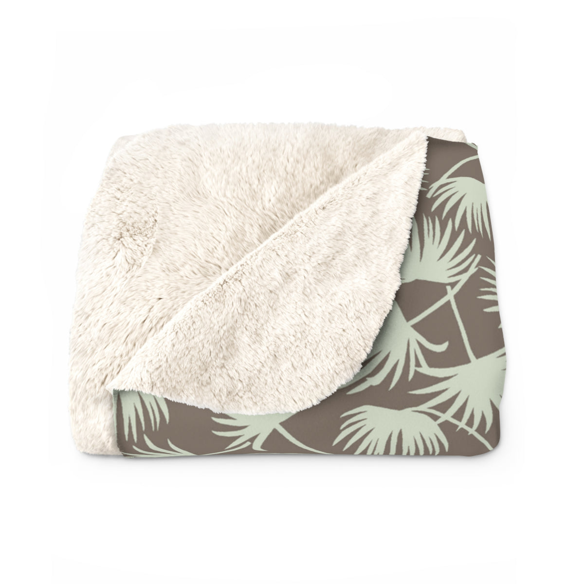 A folded plush throw blanket with a cream sherpa sherpa-style sherpa side and a taupe side featuring a sage green palm leaf pattern.