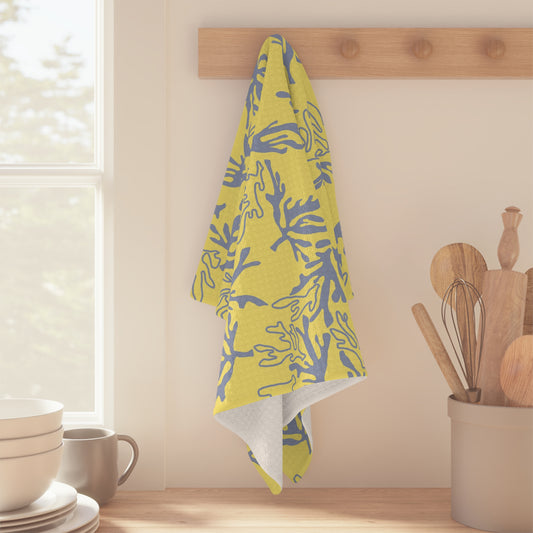 Coral Yellow and Grey microfiber kitchen towel featuring an original island-inspired coral reef pattern by Global Village Kailua pattern hanging from a wooden peg rack on a kitchen wall.