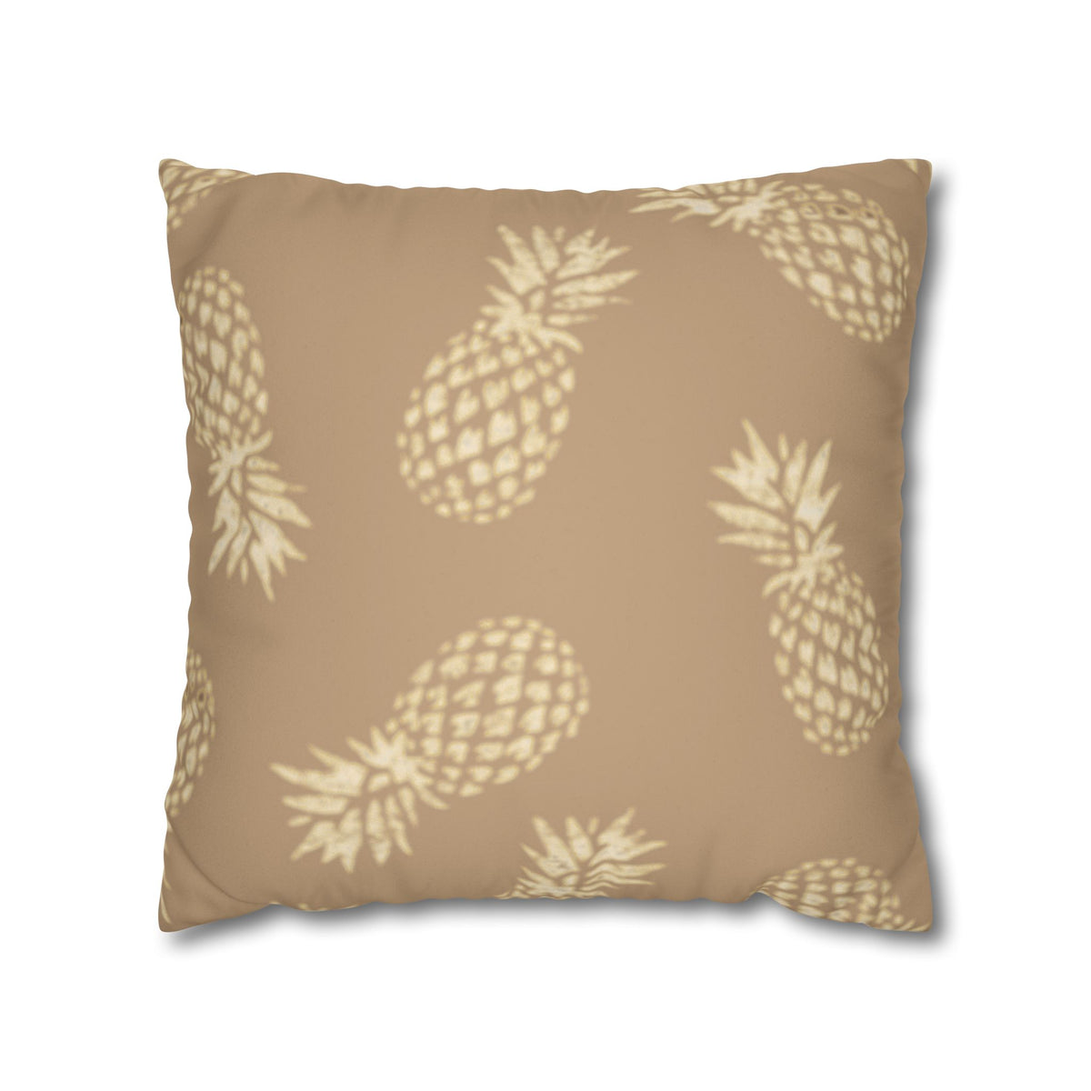 A square throw pillow featuring a beige and cream pineapple pattern on a solid tan background, shown against a plain white background.