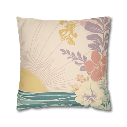 A square decorative throw pillow featuring a tropical beach design with a yellow sun, teal ocean waves, and hibiscus flowers in purple, coral, and cream on a light beige background.
