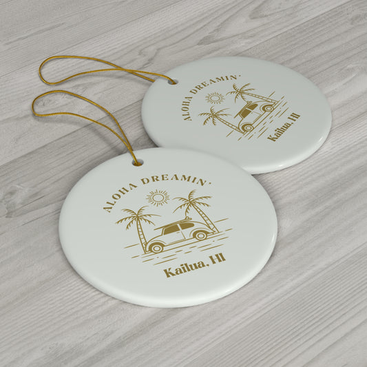 White ceramic ornament with gold Aloha Dreamin’ Kailua HI design featuring a retro surf car, palm trees and sun.