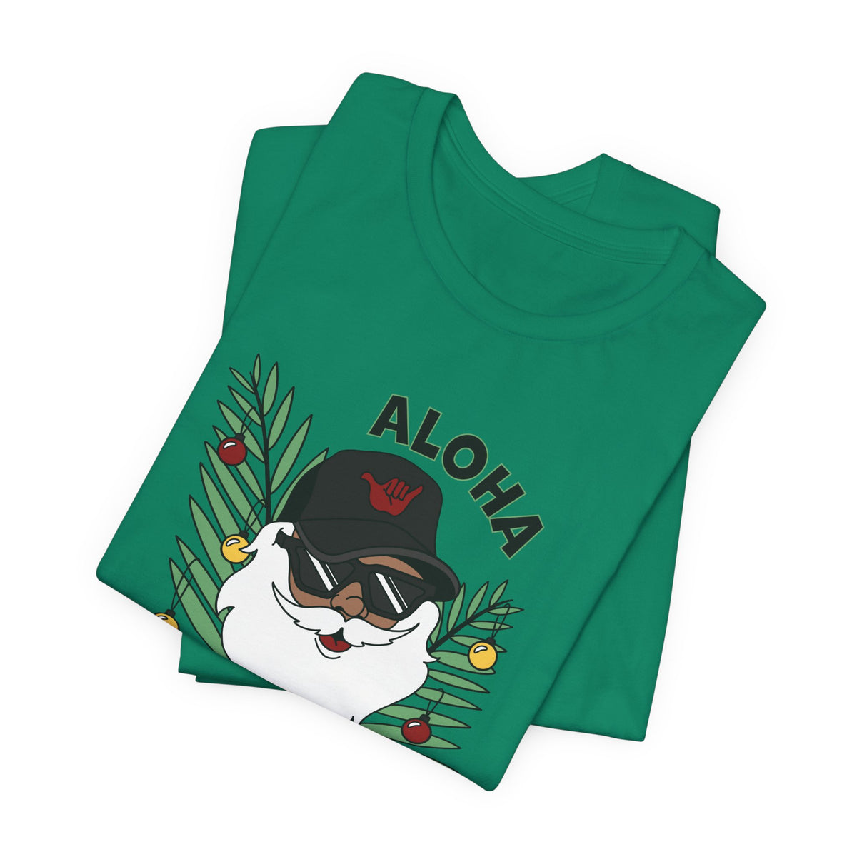 Folded Kelly Green Santa Kalikimaka unisex T-shirt with hand-drawn Santa wearing sunglasses and throwing a shaka surrounded by tropical palm leaves.