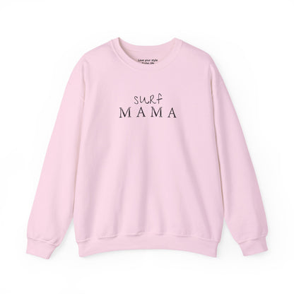 A light pink crewneck sweatshirt with 'surf MAMA' printed in black across the chest, displayed flat against a white background.