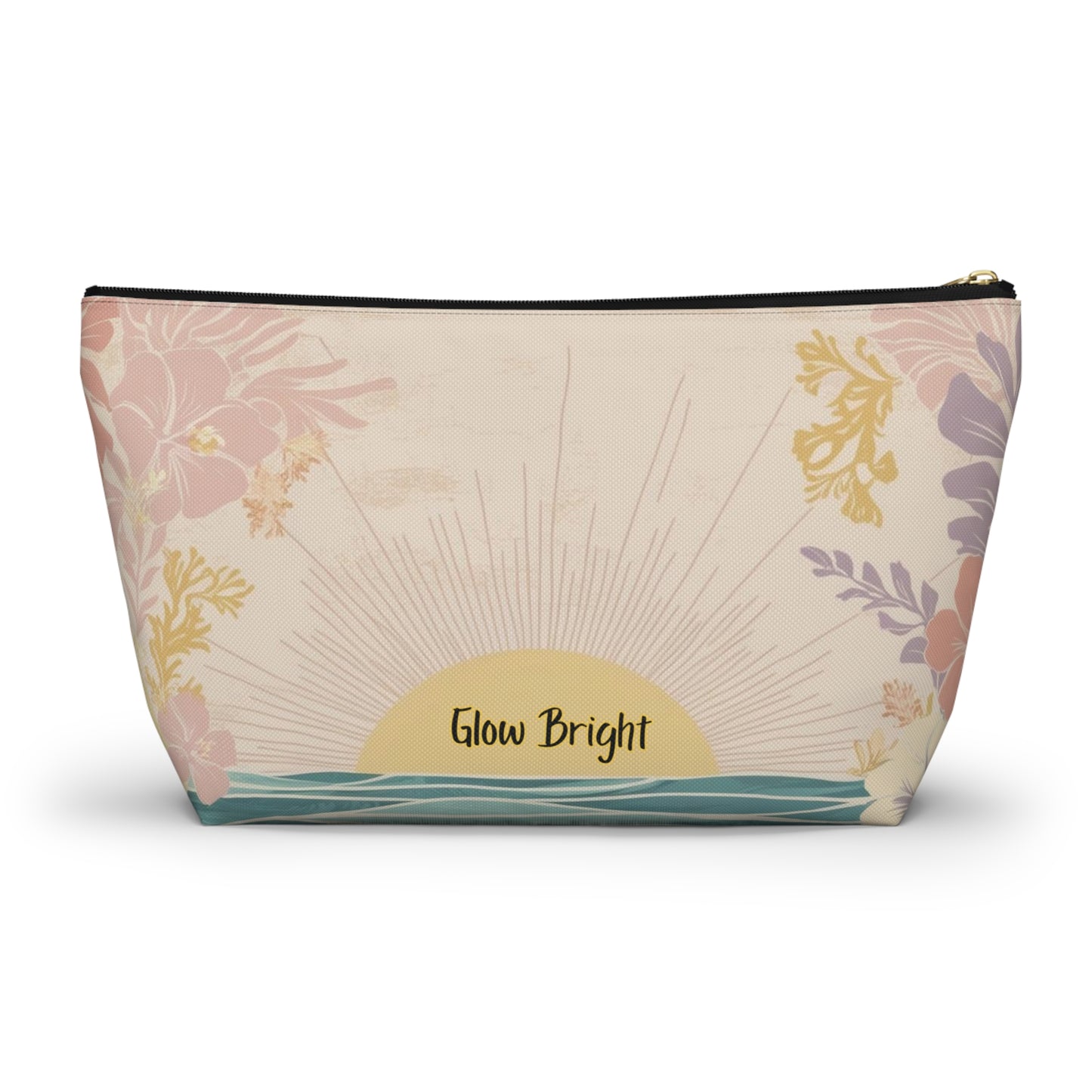 A rectangular zippered pouch with a tropical sunset print, featuring pink and purple flowers, a yellow sunburst, and the text 'Glow Bright' on a cream background.