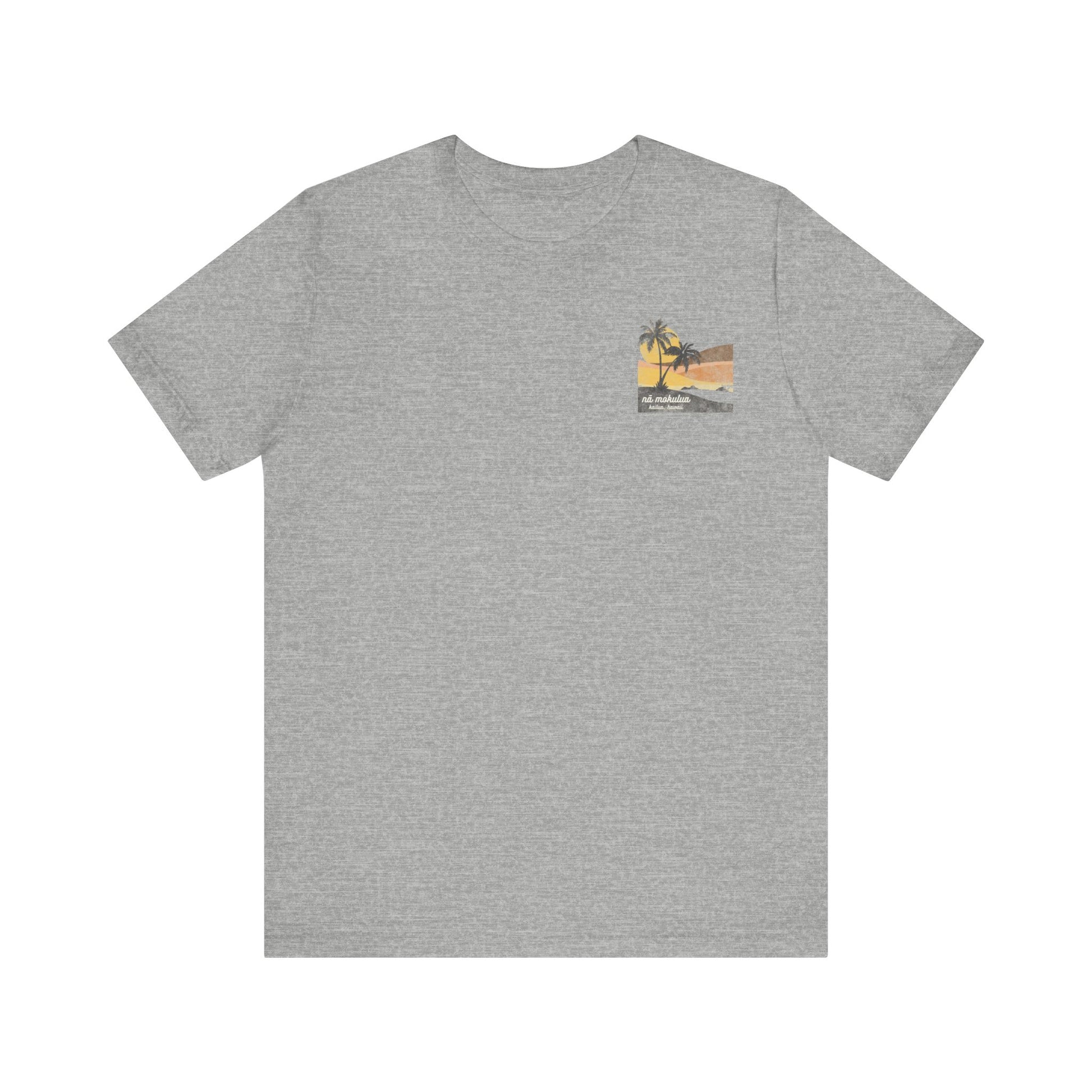 A heather grey short-sleeve t-shirt with a vintage-style graphic on the front left chest depicting two palm trees against a yellow and orange sunset, with the text 'ná makulua' and 'Kailua, Hawaii!' printed below.