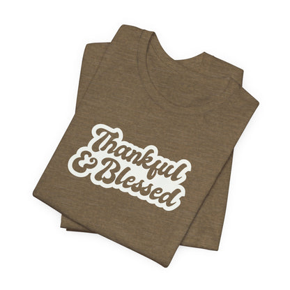 A folded heather olive t-shirt with 'Thankful & Blessed' printed in a white and brown retro-style font, displayed on a clean white background.