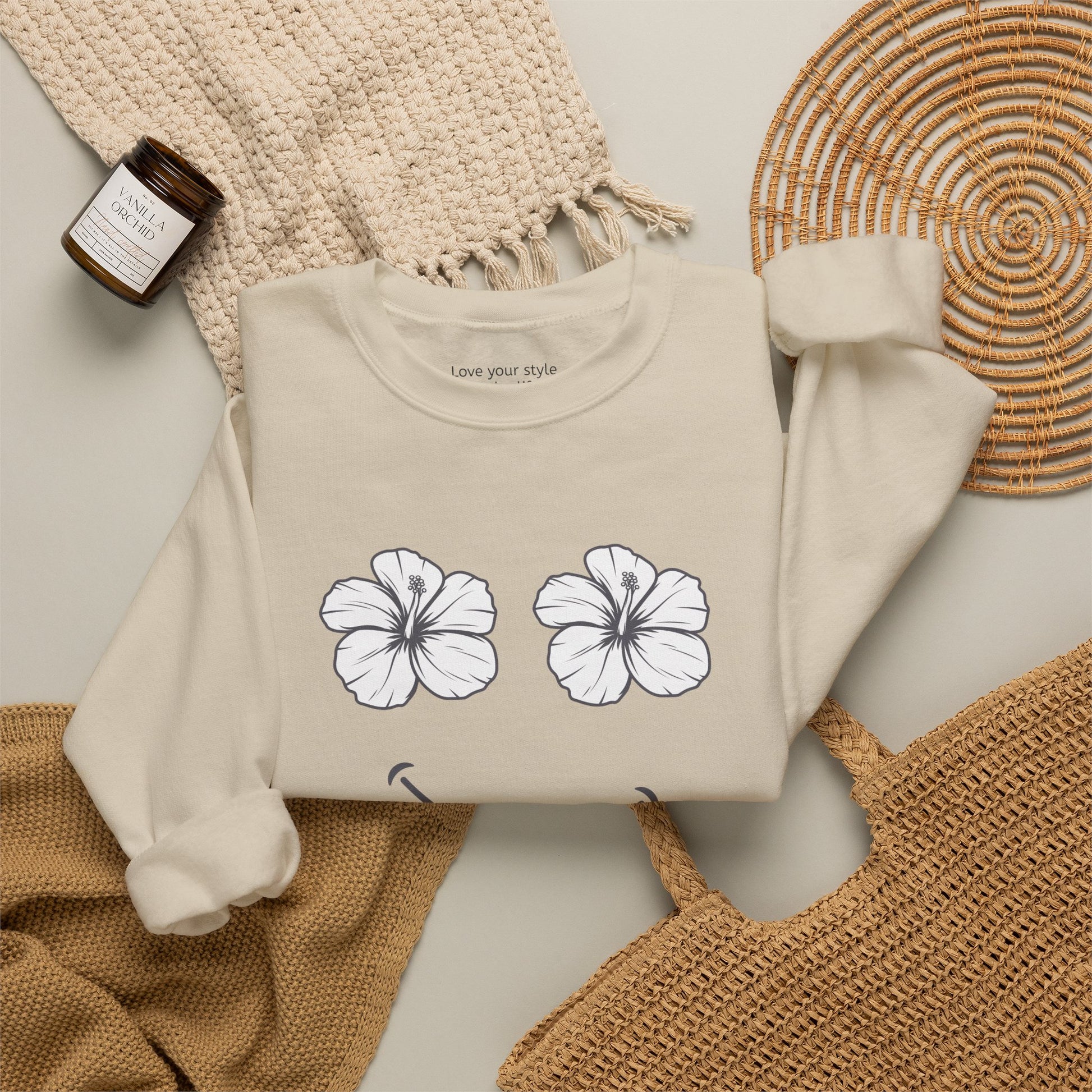 Tan Beige folded Happy Hibiscus Sweatshirt featuring a cheerful hibiscus flower smile design inspired by island life and aloha style.